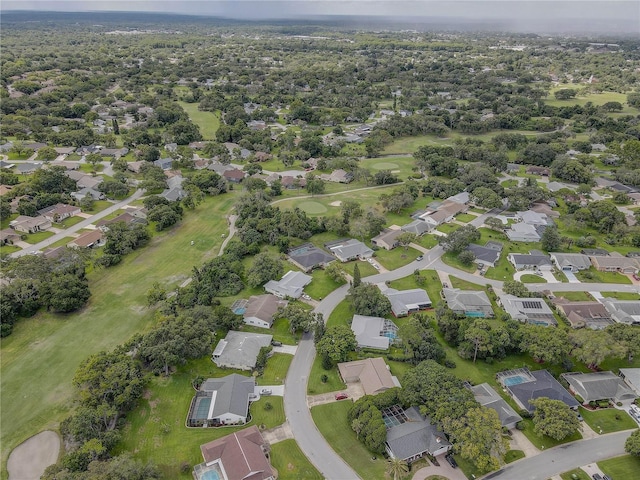 13006 Pebble Beach Cir, Hudson, FL 34667 - aerial view of property and surrounding area featuring nearby suburban area and a local golf course