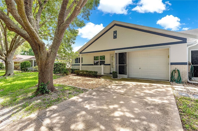 9664 SW 94th Ter Unit A, Ocala, FL 34481 - view of front of property with brick siding, an attached garage, covered porch, stucco siding, and concrete driveway