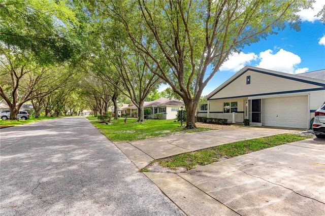 9664 SW 94th Ter Unit A, Ocala, FL 34481 - ranch-style house featuring a garage, driveway, a front lawn, and stucco siding