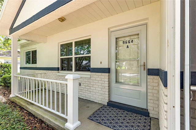 9664 SW 94th Ter Unit A, Ocala, FL 34481 - property entrance with covered porch, brick siding, and stucco siding