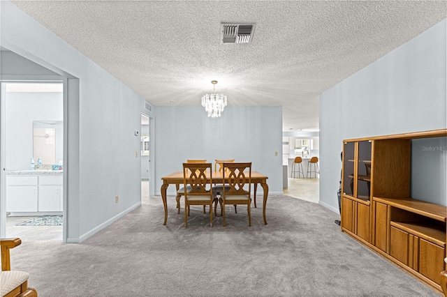 9664 SW 94th Ter Unit A, Ocala, FL 34481 - dining area with a chandelier, carpet flooring, and a textured ceiling
