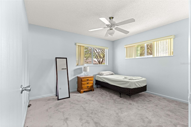 9664 SW 94th Ter Unit A, Ocala, FL 34481 - carpeted bedroom with a textured ceiling and a ceiling fan