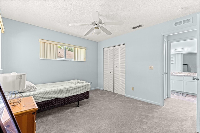 9664 SW 94th Ter Unit A, Ocala, FL 34481 - bedroom with carpet, a closet, ceiling fan, and a textured ceiling