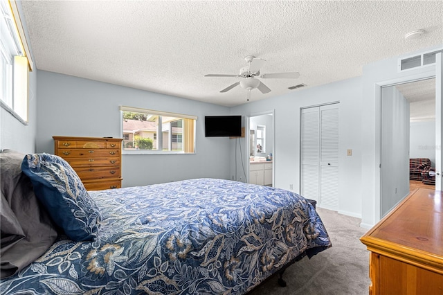 9664 SW 94th Ter Unit A, Ocala, FL 34481 - carpeted bedroom featuring a closet, a textured ceiling, ceiling fan, and ensuite bath