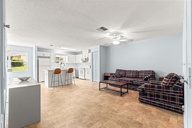 9664 SW 94th Ter Unit A, Ocala, FL 34481 - living room with ceiling fan and a textured ceiling