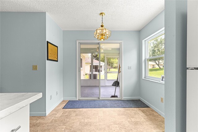 9664 SW 94th Ter Unit A, Ocala, FL 34481 - foyer featuring a chandelier, a textured ceiling, and ceiling fan