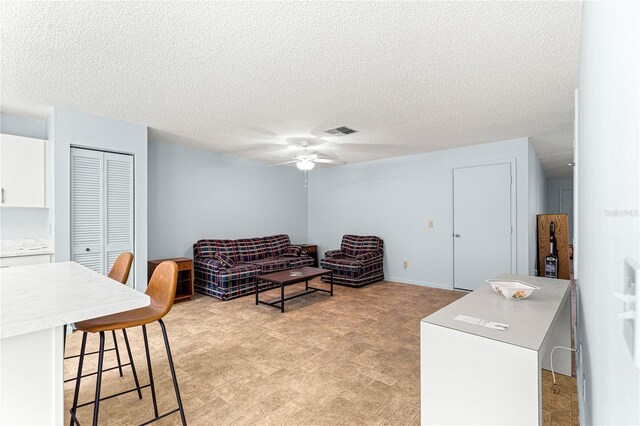 9664 SW 94th Ter Unit A, Ocala, FL 34481 - living area with ceiling fan, a textured ceiling, and light flooring