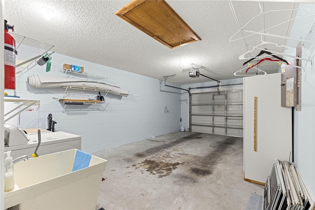 9664 SW 94th Ter Unit A, Ocala, FL 34481 - garage featuring washer and clothes dryer, a garage door opener, and concrete block wall