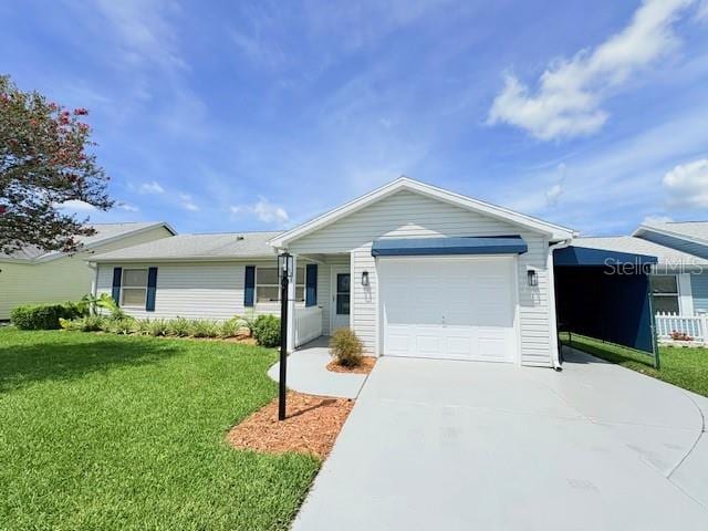 528 Valencia Pl, Lady Lake, FL 32159 - ranch-style house featuring a garage, concrete driveway, and a front lawn