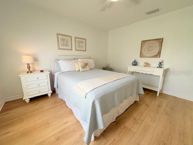 528 Valencia Pl, Lady Lake, FL 32159 - bedroom featuring light wood finished floors and a ceiling fan
