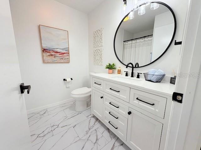 528 Valencia Pl, Lady Lake, FL 32159 - bathroom with marble finish floors and vanity