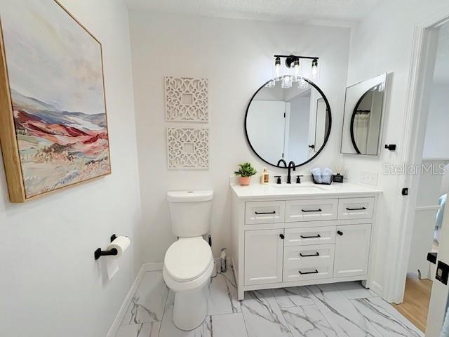 528 Valencia Pl, Lady Lake, FL 32159 - bathroom featuring marble look tile flooring and vanity