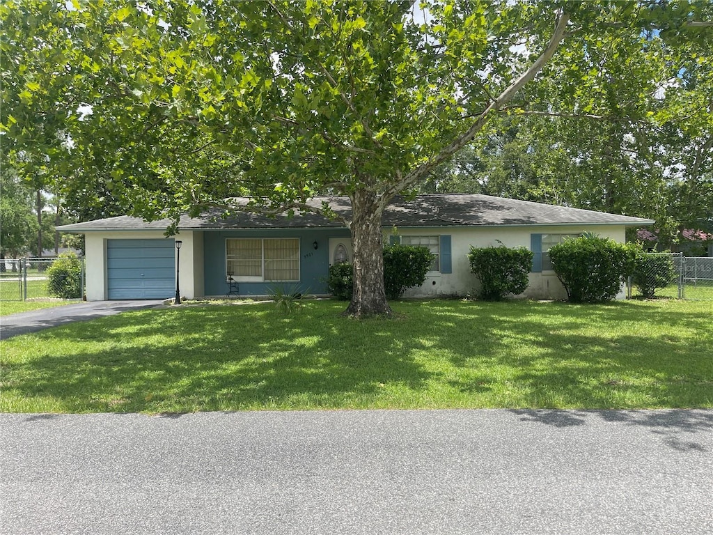 5501 SE 2nd Pl, Ocala, FL 34480 - view of front facade with stucco siding, a garage, and asphalt driveway