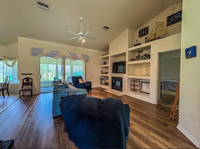 8671 SW 57th Court Rd, Ocala, FL 34476 - living room with dark wood finished floors, ceiling fan, a tiled fireplace, built in features, and high vaulted ceiling