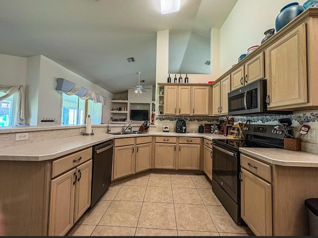 8671 SW 57th Court Rd, Ocala, FL 34476 - kitchen with black range with electric stovetop, dishwasher, vaulted ceiling, a peninsula, and light countertops