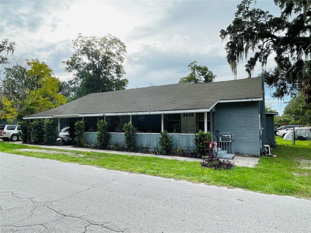 805 NW 24th Pl, Ocala, FL 34475 - view of front of home with a front lawn and brick siding