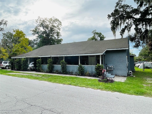 805 NW 24th Pl, Ocala, FL 34475 - view of front of home with a front lawn and brick siding