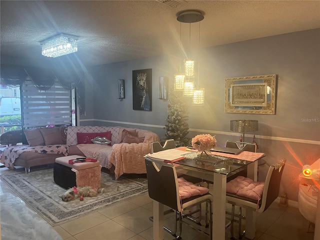 3106 S Semoran Blvd Unit 5, Orlando, FL 32822 - dining room featuring a textured ceiling, tile patterned flooring, and a chandelier
