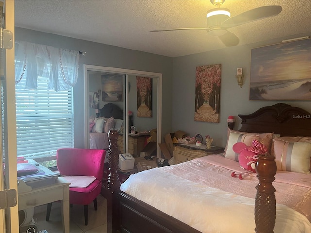 3106 S Semoran Blvd Unit 5, Orlando, FL 32822 - tiled bedroom with a textured ceiling, multiple windows, a closet, and a ceiling fan
