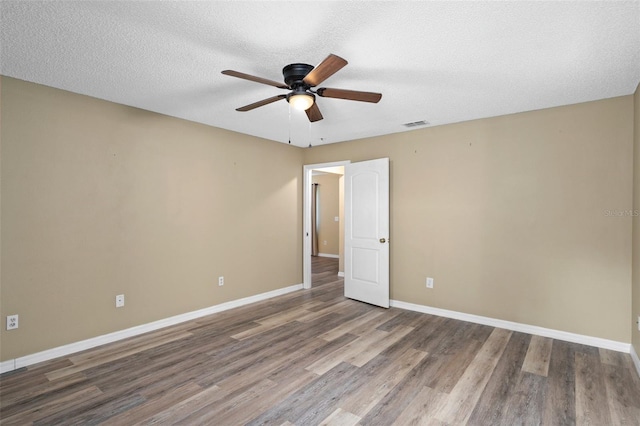 3224 E Davis Ln Unit 29, Inverness, FL 34453 - empty room with ceiling fan, wood finished floors, and a textured ceiling
