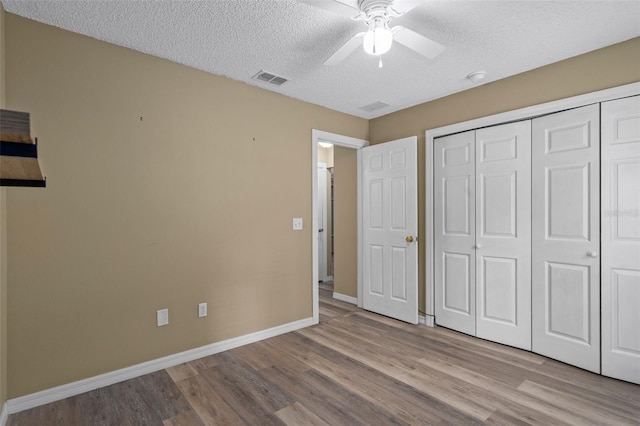 3224 E Davis Ln Unit 29, Inverness, FL 34453 - unfurnished bedroom with wood finished floors, a textured ceiling, a closet, and ceiling fan