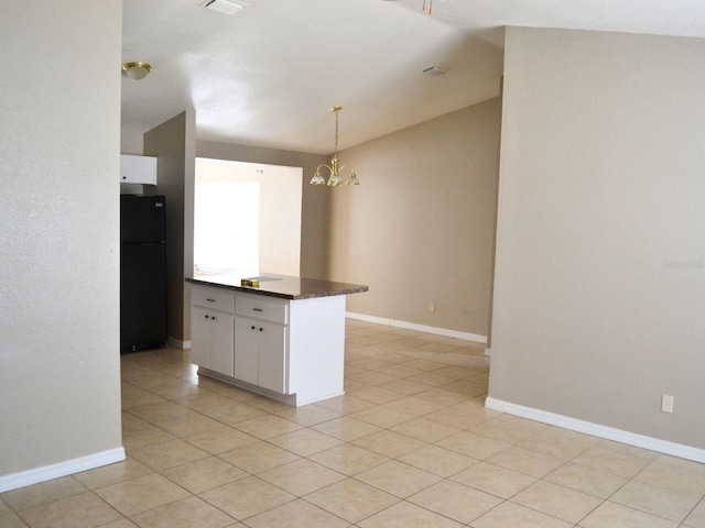 254 Marion Oaks Mnr, Ocala, FL 34473 - kitchen with freestanding refrigerator, dark countertops, a chandelier, white cabinets, and lofted ceiling