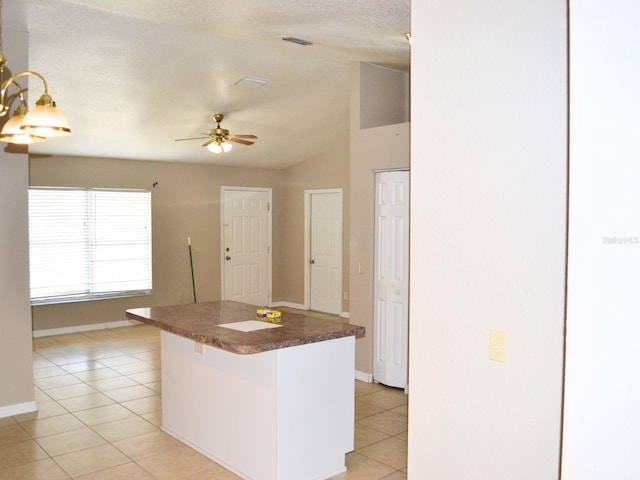 254 Marion Oaks Mnr, Ocala, FL 34473 - kitchen featuring light tile patterned floors, vaulted ceiling, ceiling fan, dark countertops, and a kitchen island
