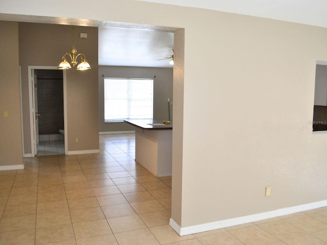 254 Marion Oaks Mnr, Ocala, FL 34473 - empty room with a chandelier, a ceiling fan, and light tile patterned flooring