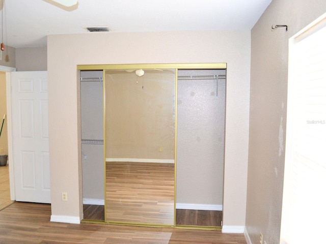 254 Marion Oaks Mnr, Ocala, FL 34473 - unfurnished bedroom with wood finished floors and a closet