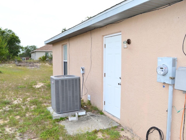 254 Marion Oaks Mnr, Ocala, FL 34473 - view of home's exterior with a central air condition unit and stucco siding