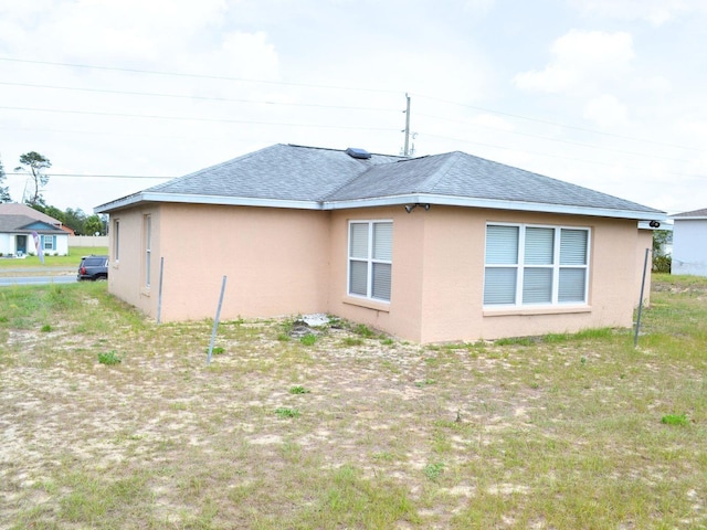 254 Marion Oaks Mnr, Ocala, FL 34473 - view of property exterior with stucco siding and a shingled roof