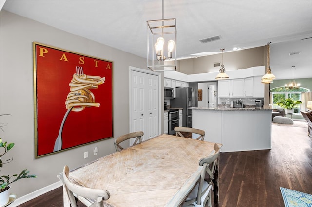 1882 E Monopoly Loop, Inverness, FL 34453 - dining space with a chandelier and dark wood-type flooring
