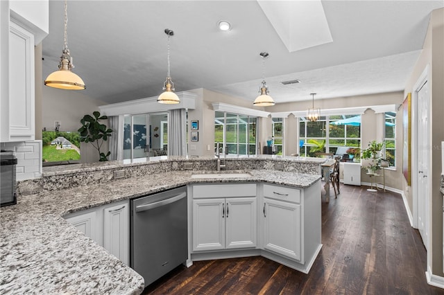 1882 E Monopoly Loop, Inverness, FL 34453 - kitchen featuring dishwasher, light stone counters, a skylight, dark wood finished floors, and pendant lighting