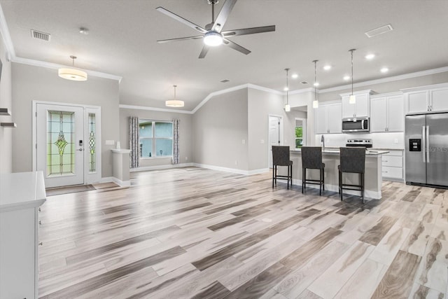 837 E Epsom Ct, Hernando, FL 34442 - kitchen featuring appliances with stainless steel finishes, crown molding, healthy amount of natural light, white cabinets, and recessed lighting