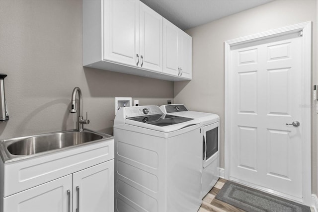 837 E Epsom Ct, Hernando, FL 34442 - laundry room featuring washing machine and clothes dryer, cabinet space, and light wood-type flooring