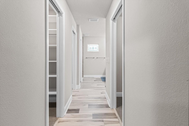 837 E Epsom Ct, Hernando, FL 34442 - hall featuring a textured wall and light wood-style floors