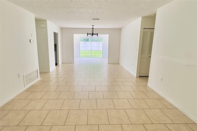 15091 SW 35th Cir, Ocala, FL 34473 - spare room featuring a textured ceiling and a chandelier