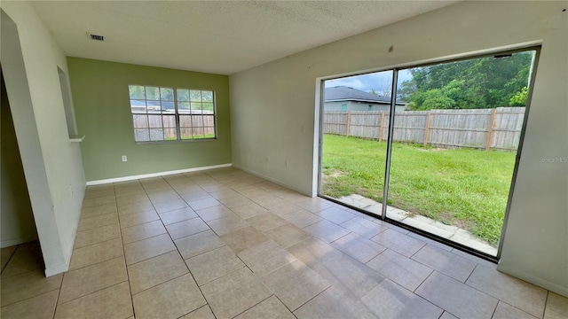 15091 SW 35th Cir, Ocala, FL 34473 - tiled spare room featuring baseboards and a textured ceiling