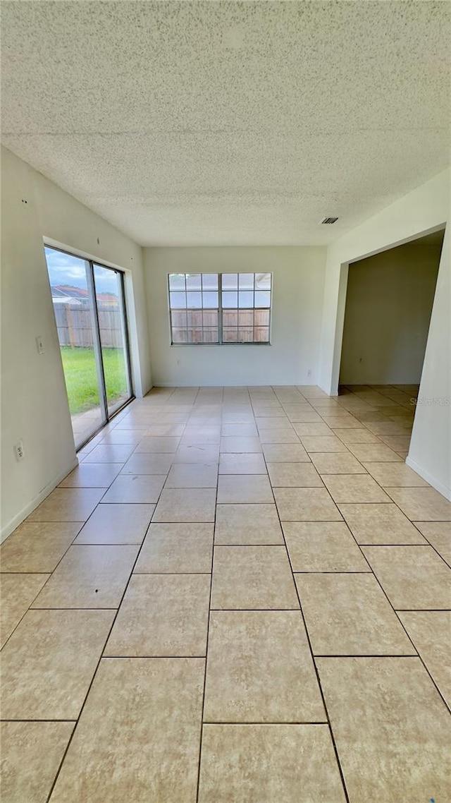 15091 SW 35th Cir, Ocala, FL 34473 - spare room featuring a textured ceiling and light tile patterned flooring