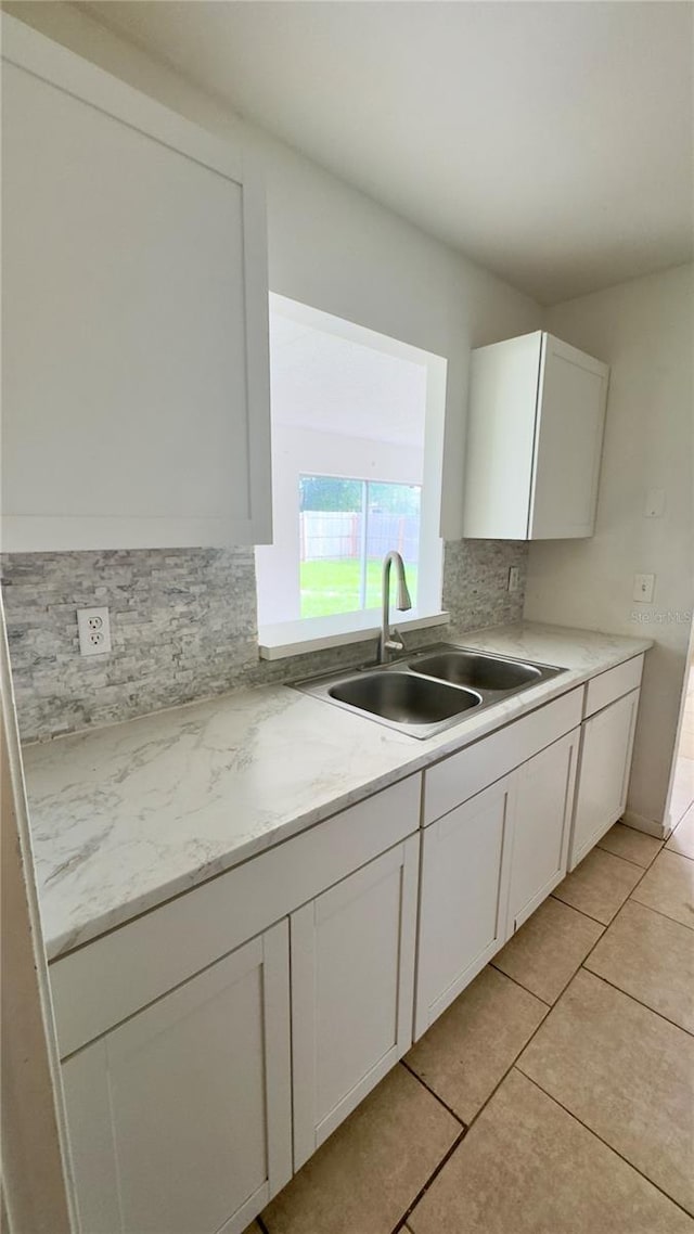 15091 SW 35th Cir, Ocala, FL 34473 - kitchen featuring tasteful backsplash, white cabinetry, and light tile patterned floors