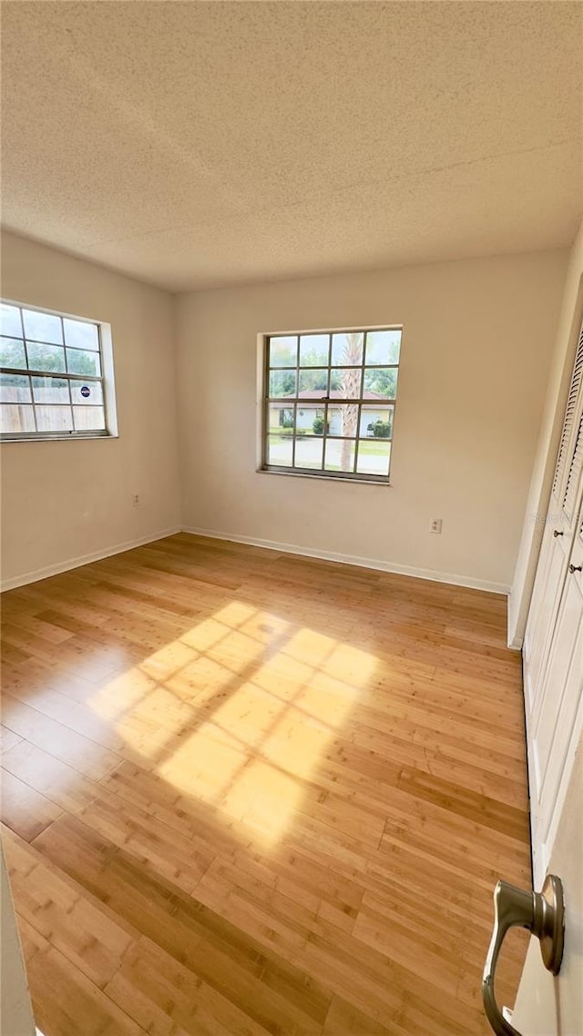 15091 SW 35th Cir, Ocala, FL 34473 - unfurnished room featuring light wood-type flooring and a textured ceiling