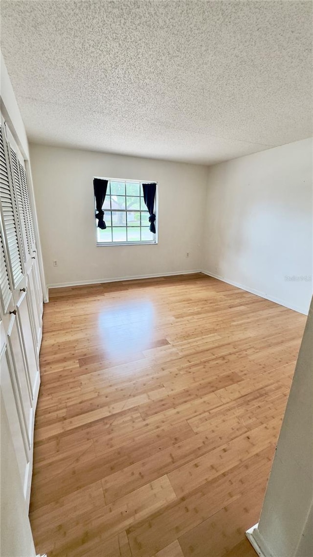 15091 SW 35th Cir, Ocala, FL 34473 - spare room featuring light wood-style flooring and a textured ceiling
