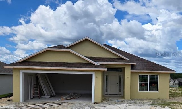 455 W Rexford Dr, Beverly Hills, FL 34465 - view of front of home with stucco siding, an attached garage, and a shingled roof