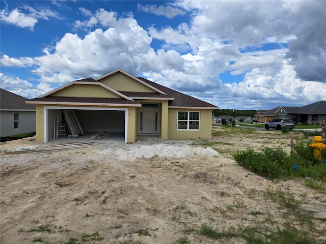 455 W Rexford Dr, Beverly Hills, FL 34465 - view of front facade with stucco siding, a garage, and a shingled roof