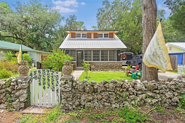 11 62nd St, Yankeetown, FL 34498 - rear view of house with a sunroom, a metal roof, and a yard