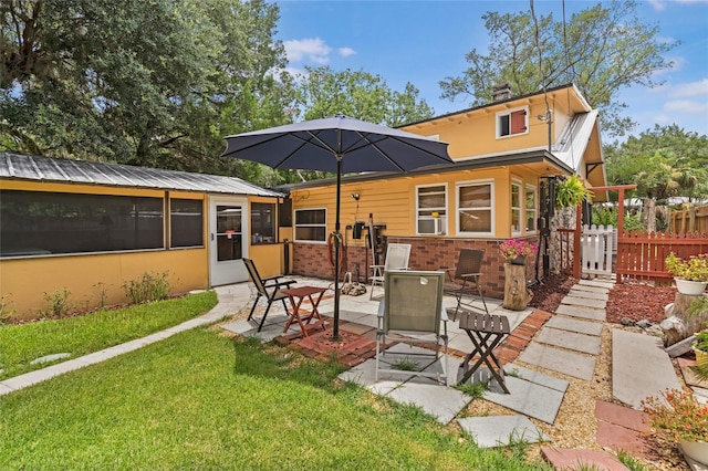 11 62nd St, Yankeetown, FL 34498 - back of house featuring a patio area, brick siding, and a sunroom