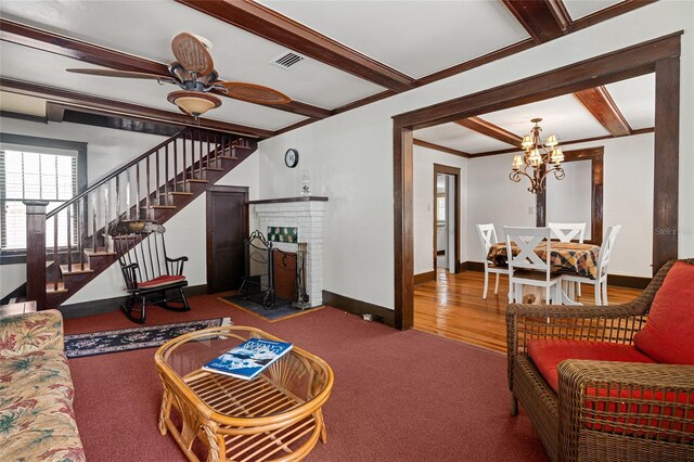 11 62nd St, Yankeetown, FL 34498 - carpeted living area with a chandelier, beam ceiling, stairway, and a ceiling fan