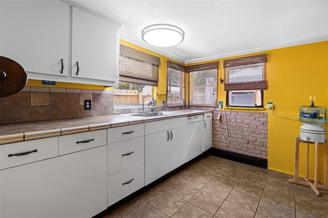 11 62nd St, Yankeetown, FL 34498 - kitchen featuring tile counters, white cabinetry, cooling unit, a textured ceiling, and dishwasher