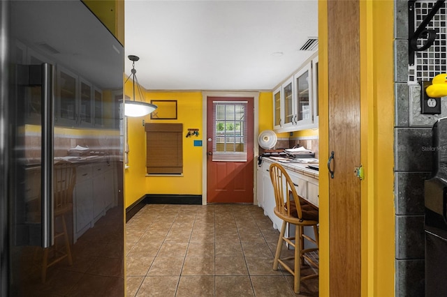 11 62nd St, Yankeetown, FL 34498 - kitchen featuring glass insert cabinets and dark tile patterned flooring
