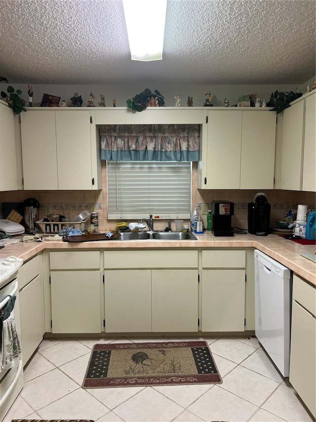 8552 SW 92nd Ln Unit C, Ocala, FL 34481 - kitchen featuring white dishwasher, stove, a textured ceiling, decorative backsplash, and light tile patterned floors